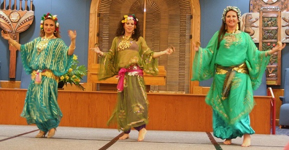 3 of the Rising Phoenix Dancers performing in T-dress variations